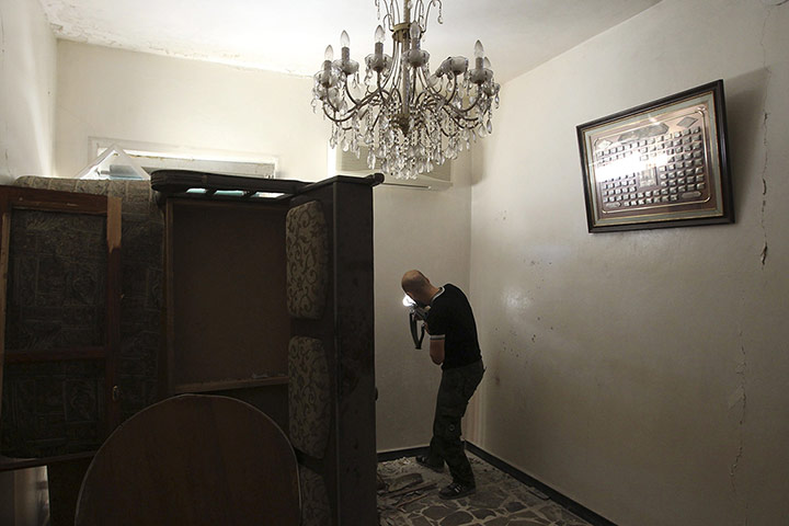 20 Photos: A Free Syrian Army fighter takes up a position inside a house in Aleppo