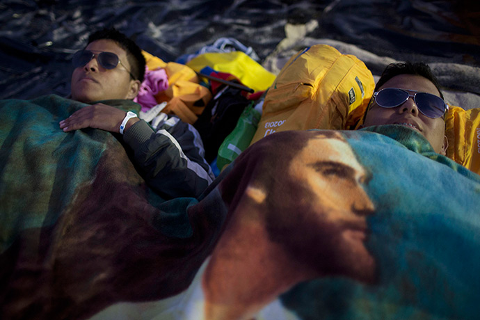 Weekend in pictures: Rio de Janeiro, Brazil,: Pilgrims rest under a blanket decorated with an im