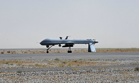 A US predator unmanned drone armed with a missile stands on the tarmac of Kandahar military airport