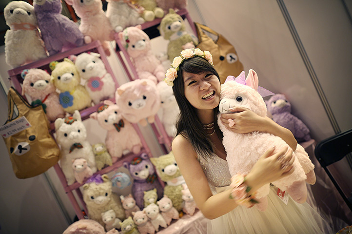 Hyper Japan London: A stall holder hugs a llama soft toy