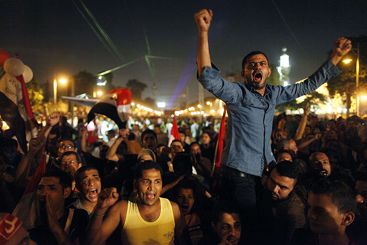 Protests in Egypt: Egyptian protesters react as they watch President Mohamed Morsi's speech