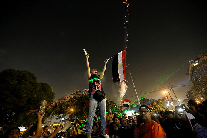 Protests in Egypt: Opponents of President Morsi react as they listen to his televised speech o