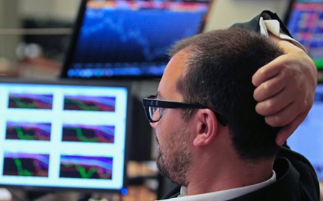 Trader watches the screens at a bank in Lisbon July 3, 2013.