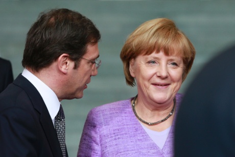 Portugal's Prime Minister Pedro Passos Coelho talks with German Chancellor Angela Merkel at an EU conference on Youth Unemployment in Berlin, July 3, 2013.