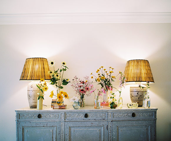 homes - stylists feature: lamps and flowers on chest of drawers