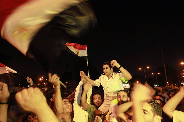Egypt Gallery Update: A policeman cheers with protesters, who are against President Mohamed Mursi