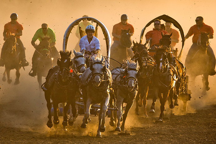 Iowa County Fair: Jamie Klatt kicks up dust as he races down a dirt track during a chuckwagon