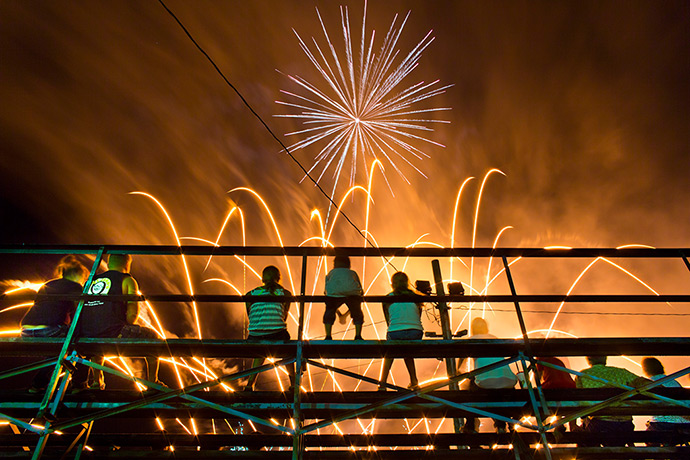 Iowa fair: Spectators watch opening night fireworks from a grandstand at the Delaware 