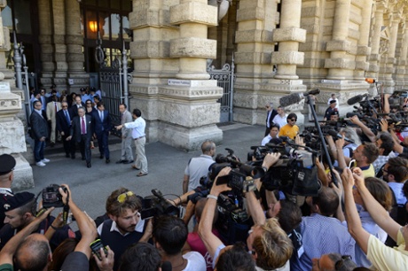 The lawyer of former Italian prime Minister Silvio Berlusconi, Franco Coppi (3rd L) walks out of the entrance of the Court of Cassation building, during a pause of the supreme court session which will decide whether to confirm former Italian Prime Minister Silvio Berlusconi's one-year prison sentence and five-year ban from politics in a long-running tax fraud case involving his media business interests, on July 30, 2013, in central Rome. The final appeal hearing began on July 30 but one of Berlusconi's lawyers told reporters that the verdict may come only on July 31 or August 1.