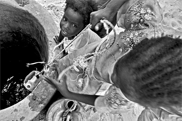 connect4climate: woman and child at well