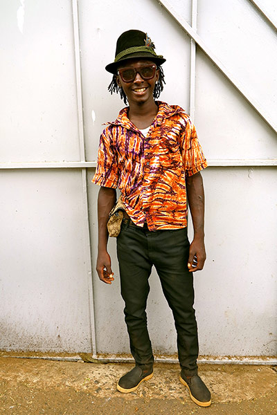 Big Picture - Africa: man in hat standing in front of white door