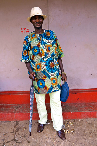 Big Picture - Africa: Man in african print shirt standing against pink background