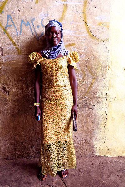 Big Picture - Africa: woman in yellow dress and purple headwrap