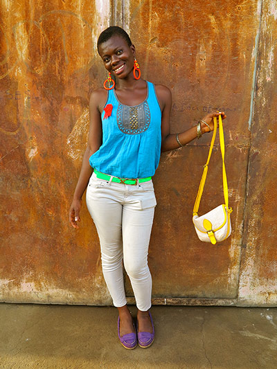Big Picture - Africa: woman in blue top and beige trousers