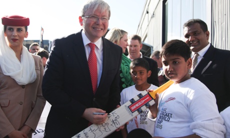Kevin Rudd signs a cricket bat during the official launch of the ICC Cricket World Cup to be held in Australia and New Zealand in 2015.
