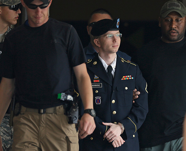Bradley Manning protests: Bradley Manning is escorted out of a courthouse in Fort Meade
