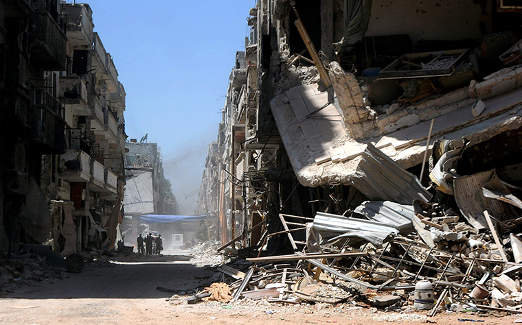 Homs destruction: Syrian army soldiers patrol in a street of Khalidiah