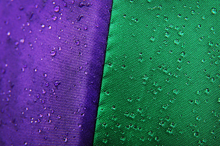 Close up Wimbledon: Rain drops glisten on a Wimbledon branded umbrella 