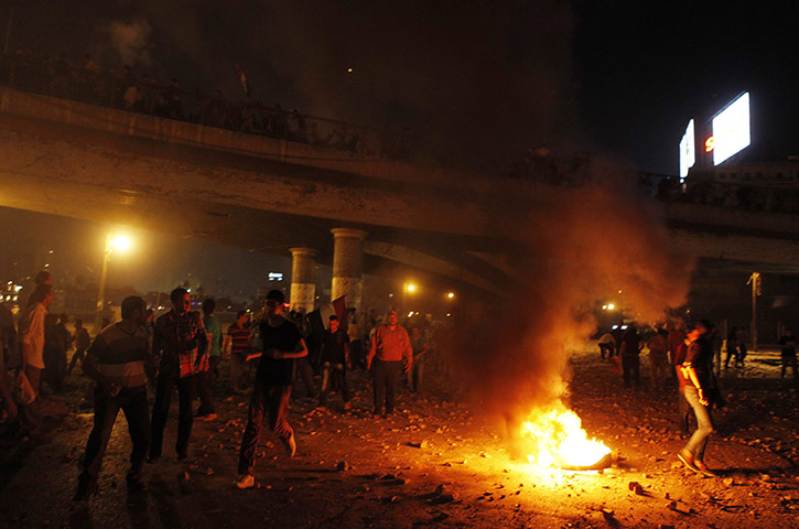 Egypt day update: Anti-Mursi protesters run during clashes the Muslim Brotherhood