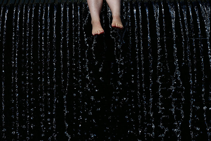 Scorcher: A girl sits on a fountain during hot weather in Nottingham