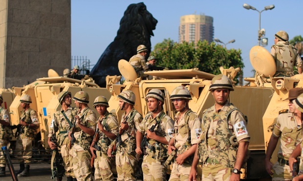 Egyptian army soldiers take their positions near armoured vehicles to guard the entrances of Tahrir Square, in Cairo, Egypt, on 8 July 2013.