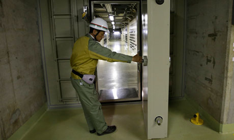A worker opens the watertight door at Chubu Electric Power Company's Hamaoka nuclear power station