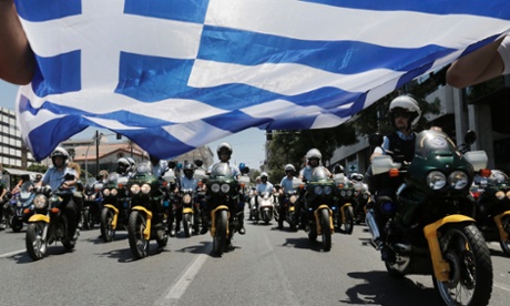 Municipal policemen ride through Athens on their motorcycles during a rally by local government workers against the public sector reforms and layoffs Greece has promised its international lenders.