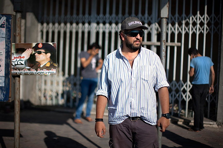 Holly Pickett pictures: Khaled El-Qadi poses next to a poster