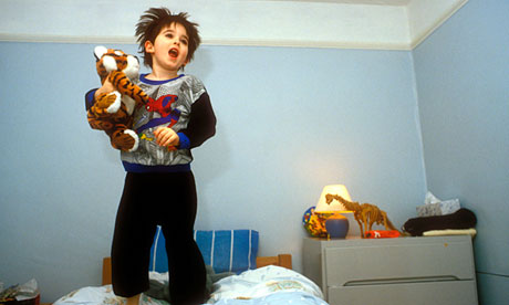 Child jumping on bed