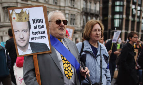 A blind man joins other protesters on a march against government cuts to disability living allowance