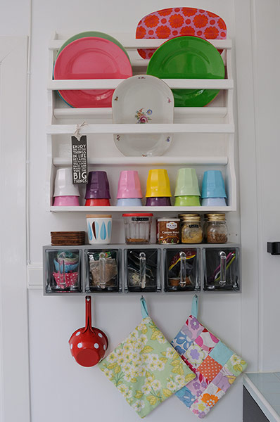 homes - norway house: white wall with white shelves and multi-coloured plates and cups