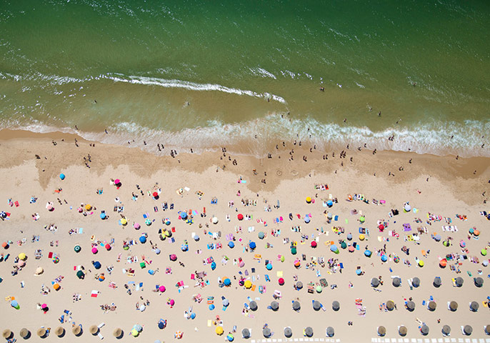 big picture - beach: overhead shot of beach with sea and umbrellas