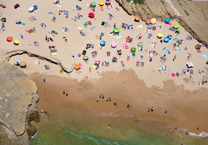 big picture - beach: overhead shot of beach with sea and umbrellas