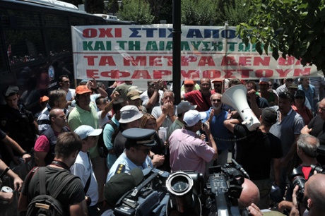 Municipal employees chants slogans in front of the ministry of administrative reform in Athens, during their protest rally on July 9, 2013.