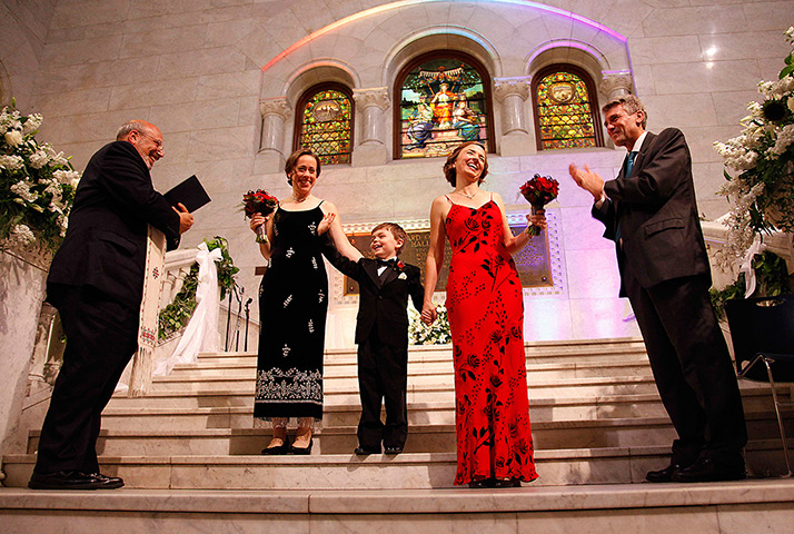 Gay weddings: Cathy ten Broeke, right, and Margaret Miles hold their son Louie's hand aft
