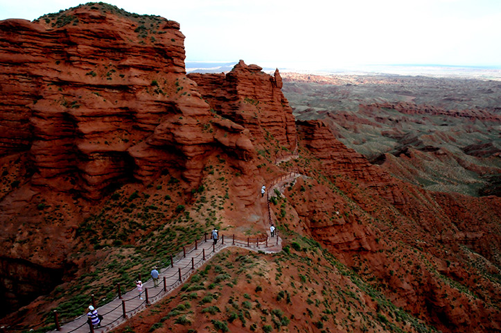 Rainbow mountains: Tourists view the scenery of Danxia landform at Pingshan Lake scenic area 
