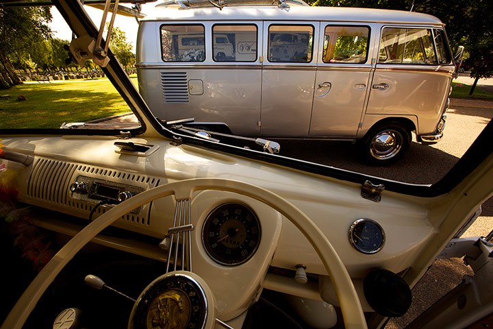 Cremation open day: A VW campervan hearse, seen from the cabin of a matching family limo car