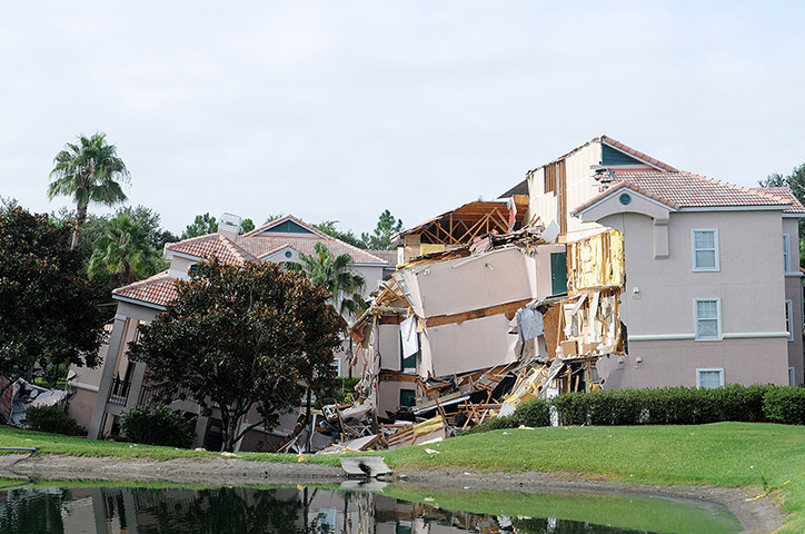 Sinkhole: Clermont, Florida: A building sits partially collapsed over a sinkhole at S