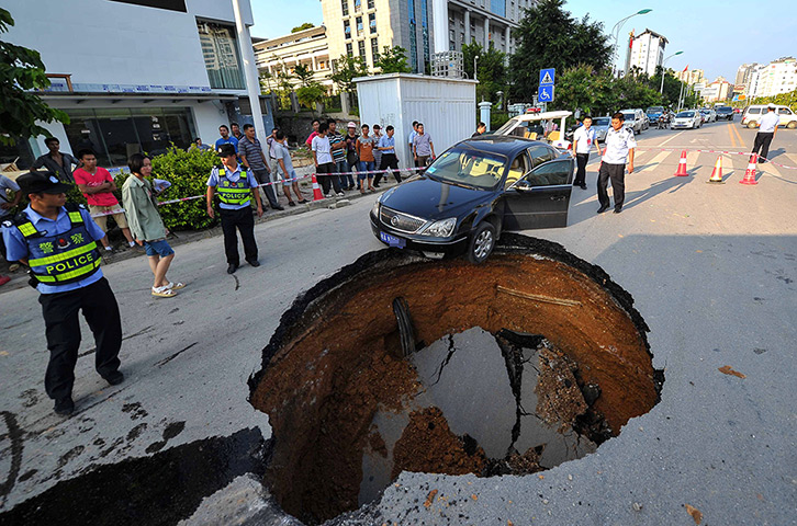 Sinkhole: Nanjing, China: A driver had a lucky escape when he narrowly managed to avo