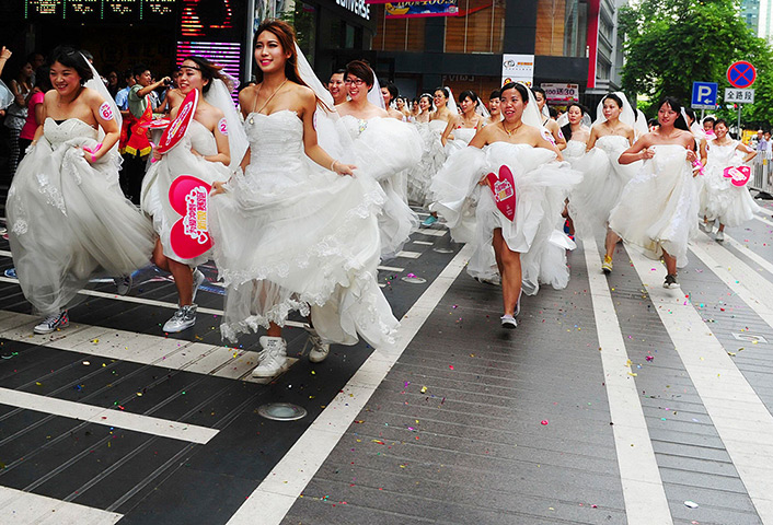 China Valentine's day: Women in wedding gowns participate in a brides' race event organized by a s
