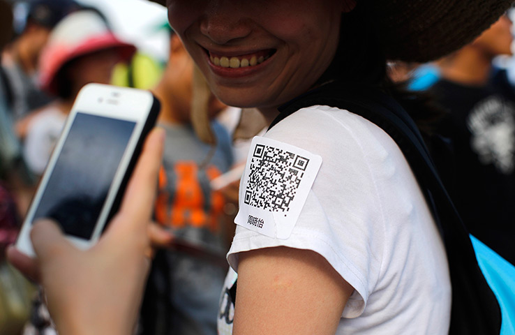 China Valentine's day: A man uses his phone to scan a QR code sticker, which is used to share pers