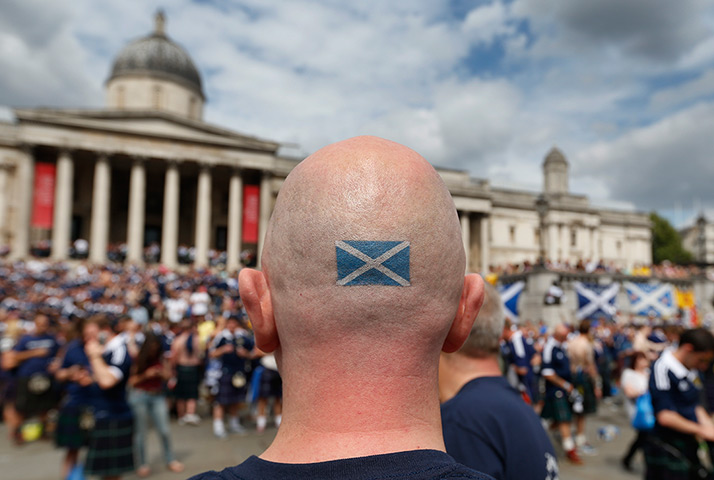Scottish fans: A Scotland fan with a Scottish flag tattoo celebrates in central London's T