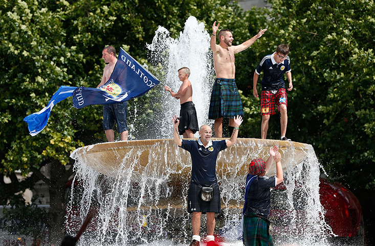 Scottish fans: Scotland's fans chant slogans as they celebrate in a fountain in Trafalgar 