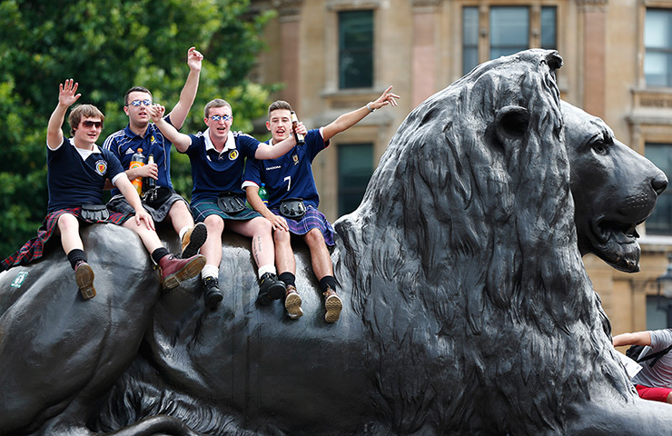Scottish fans: The Tartan Army sit on a Trafalgar Square lion