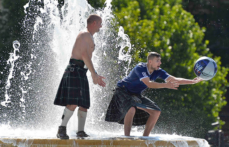 Scottish fans: Fans play in a fountain in Trafalgar Square 