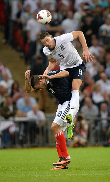 England v Scotland 2: Gary Cahill climbs above Robert Snodgrass to clear the ball