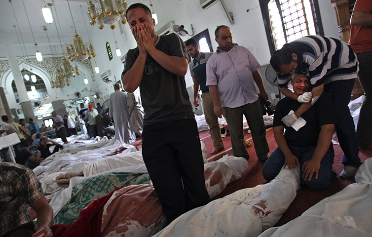 Egypt after crackdown: Egyptians mourn over the bodies of their relatives in the el-Iman mosque at Nasr City, Cairo
