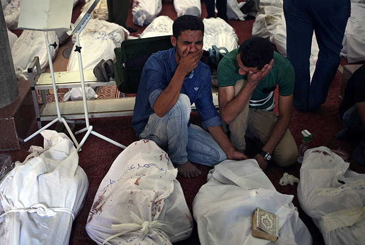 Egypt after crackdown: Egyptians mourn over the bodies of their relatives in the el-Iman mosque in Nasr City, Cairo