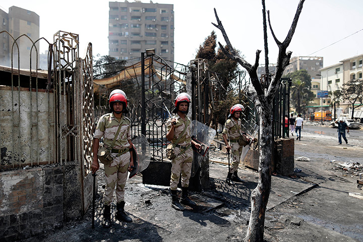 Egypt after crackdown: Soldiers stand guard outside the Rabaa al-Adawiya mosque