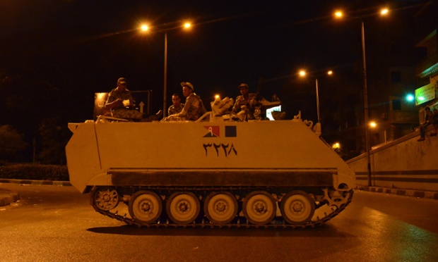 An Egyptian armoured personnel carrier (APC) is parked in the middle of Giza Street, Cairo, during a curfew, which started at 7pm on Thursday and ended at 6am on Friday. Photograph: Adham Khorshed/Demotix/Corbis